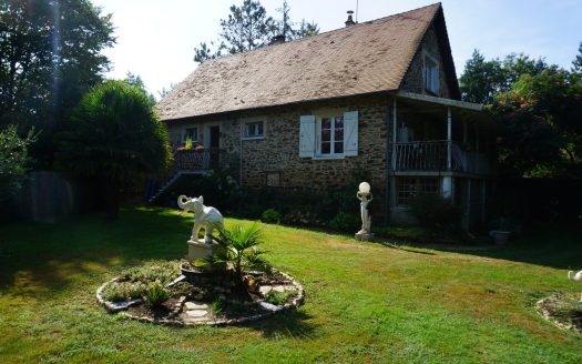 Charming stone house decorated with a pond and bordered by a river.